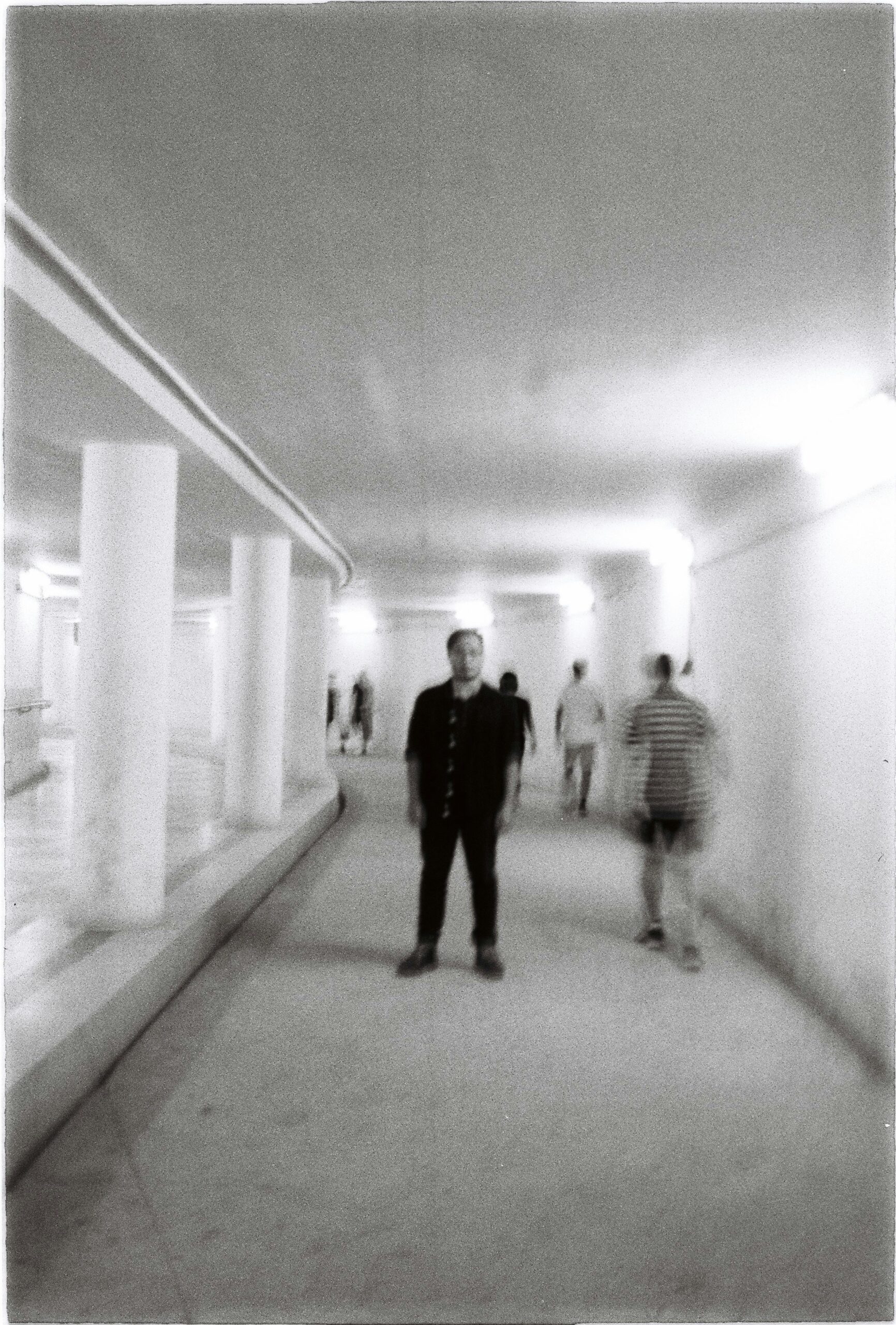 Man standing in a medical waiting room reflecting the trauma of being lost in the healthcare system