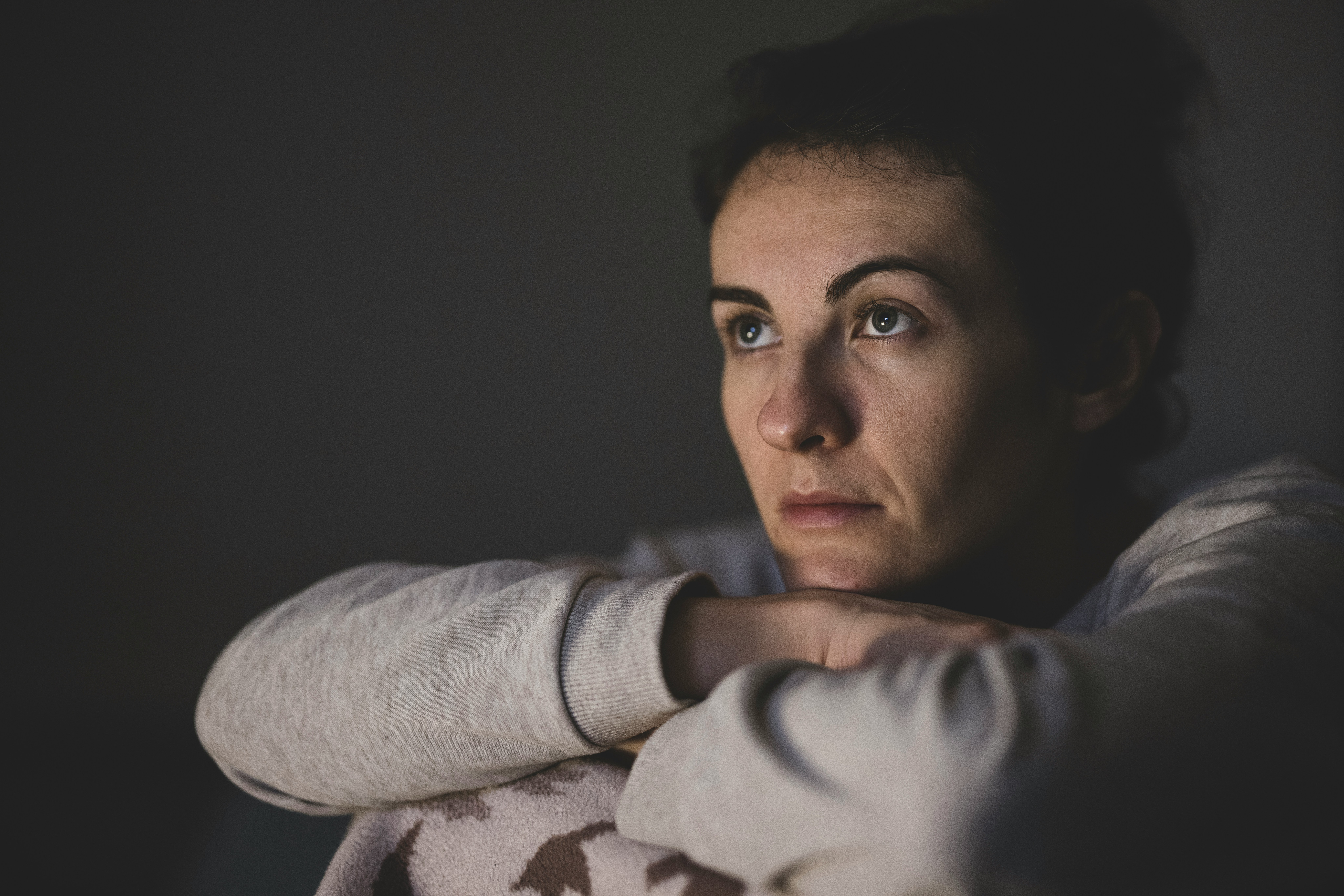 chronic illness grief of a person sitting quietly by a window